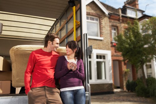 Professional movers handling office equipment